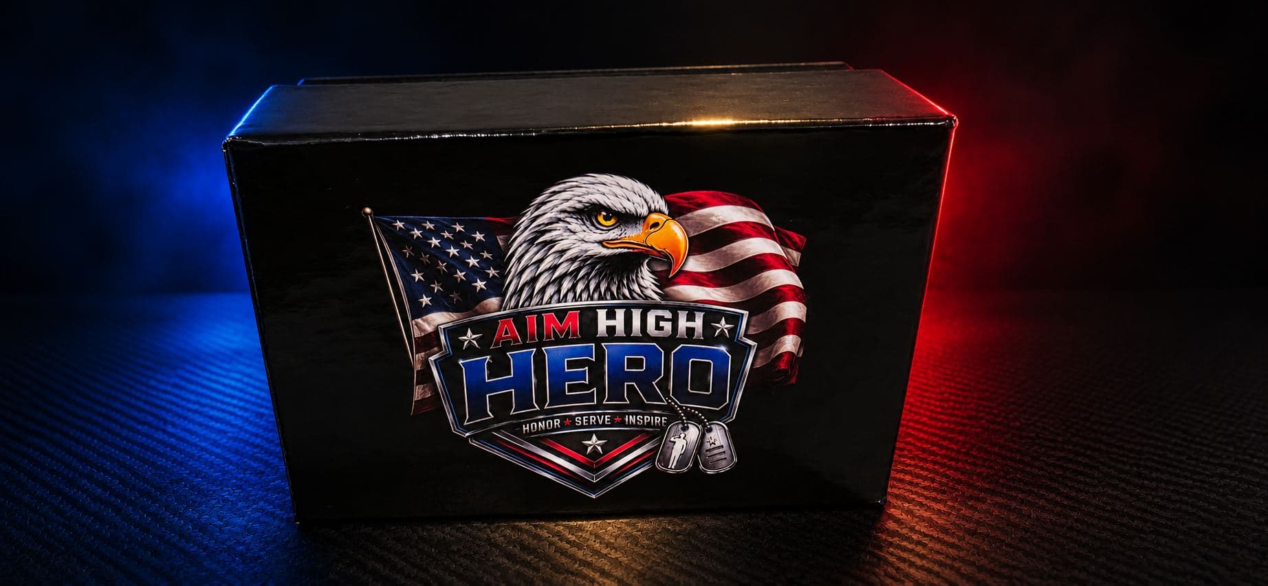 Aim High Hero black presentation box with eagle and flag mark against a dark studio backdrop