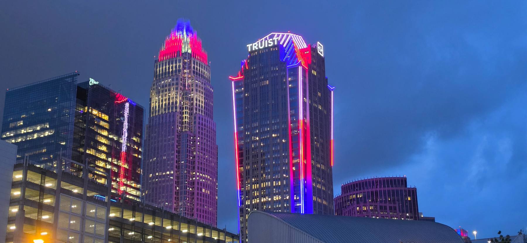 Charlotte skyline lit red, white, and blue at dusk