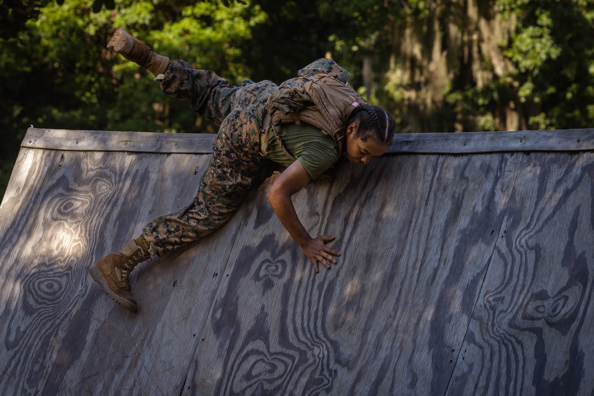 Marine recruit climbs a wooden wall during the confidence course at Parris Island